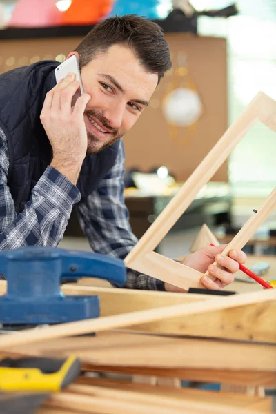 Man Using Smart Phonein Carpentry — Stock Photo, Image