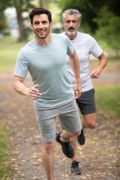 two mature men jogging in the park
