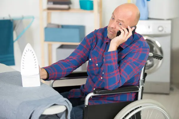Disabled Mature Man Ironing Clothes Talking Phone — Stock Photo, Image