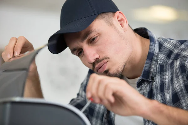 Man Repairing Photocopier Using Screwdriver — Stock Photo, Image