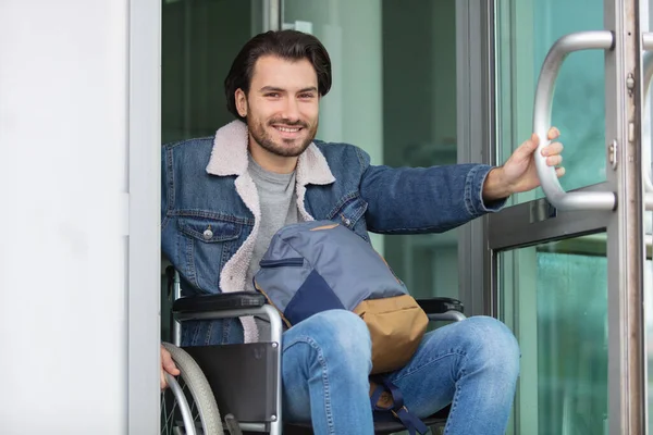Disabled Man Wheelchair Exiting Building — Stock Photo, Image