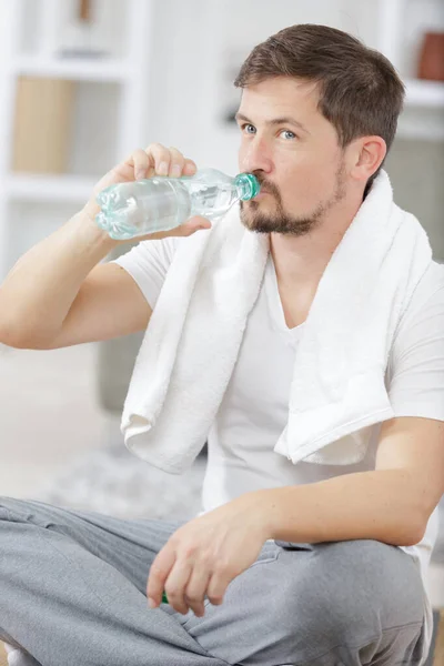 male drinking water at the gym