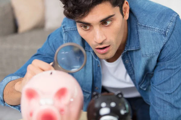 Surprised Man Looking Magnifying Glass Larger Two Piggy Banks — Stock Photo, Image