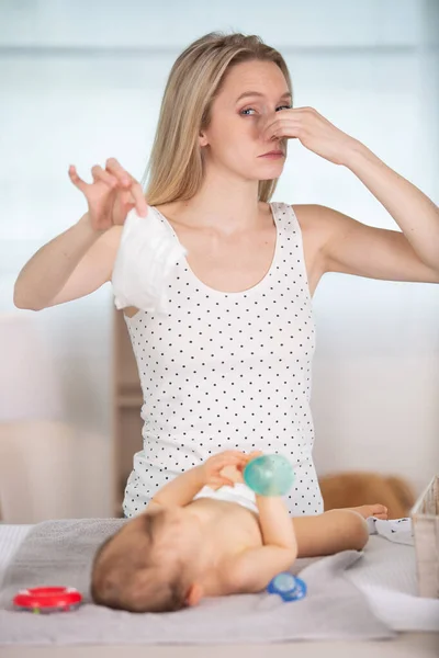 Mom Changing Stinky Diaper Her Little Daughter Table — Stock Photo, Image
