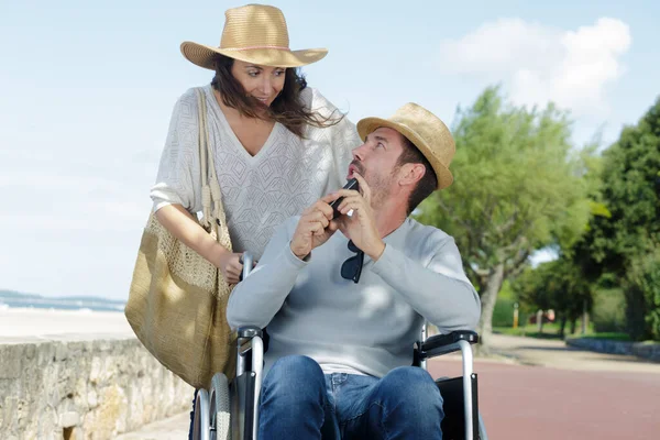 a couple in wheelchair outdoors