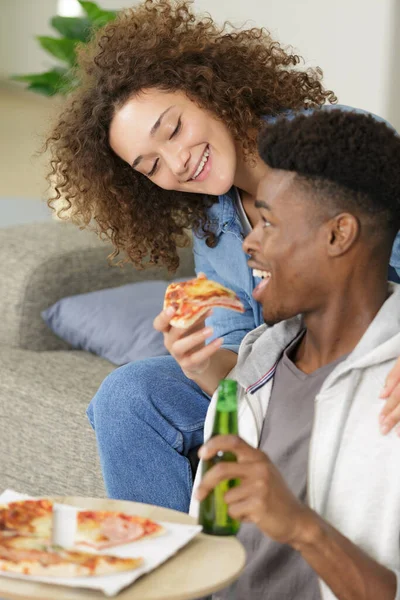 happy couple eating pizza and having a great time
