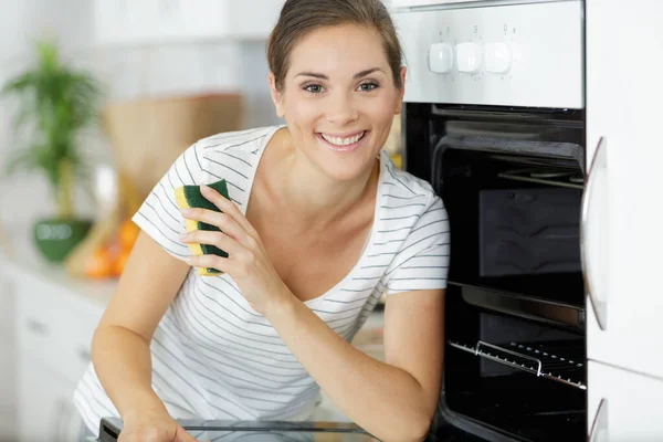 Happy Woman Cleaning Oven — Stock Photo, Image