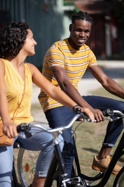 Happy Multiracial Couple Riding Bicycles — Stock Photo, Image