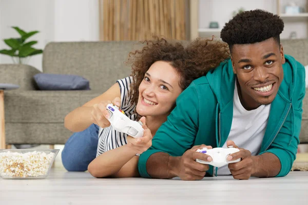 Cheerful Couple Playing Video Games While Lying Carpet — Stock Photo, Image