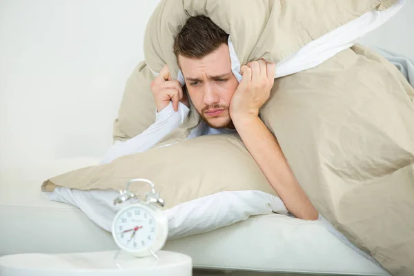 Man Bed Alarm Clock Holding Pillow Head — Stock Photo, Image