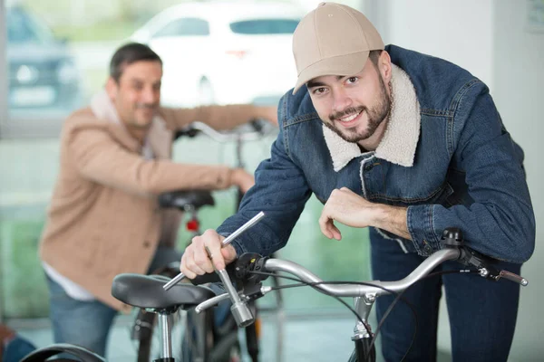 Two Men Bicycles One Holding Socket — Stock Photo, Image