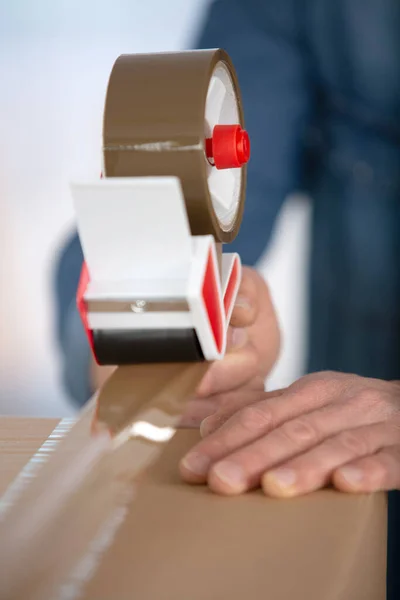 Man Holding Tape Dispenser Sealing Cardboard Box Adhesive Scotch — Stock Photo, Image
