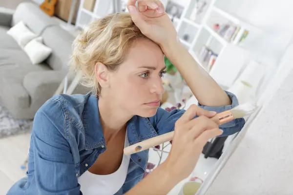 Tired Woman Resting Chair Painting Her Home — Stock Photo, Image