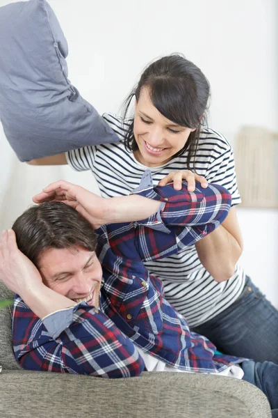 Young Couple Having Pillow Fight Sofa Stock Image