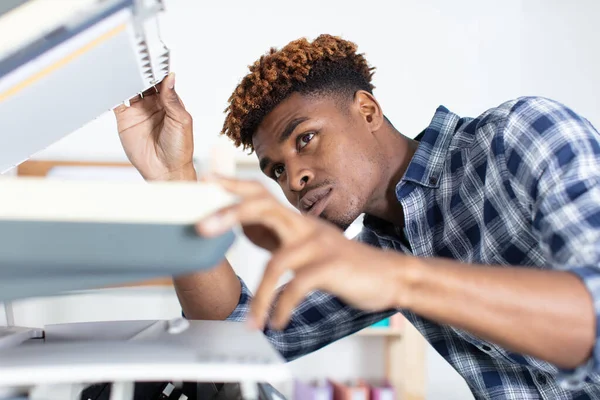 Handsome Young Man Using Copy Machine — Stock Photo, Image