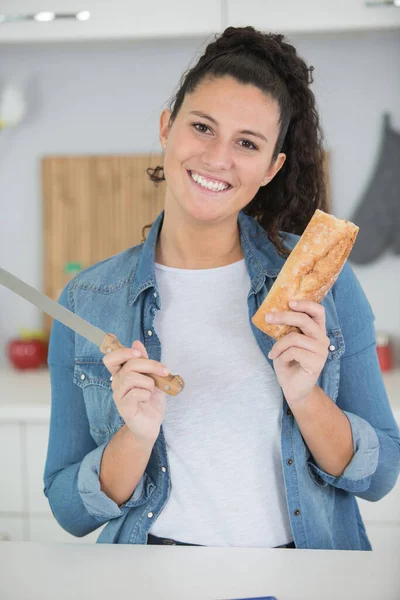 Young Woman Cutting Bread Loaf Kitchen Stock Image