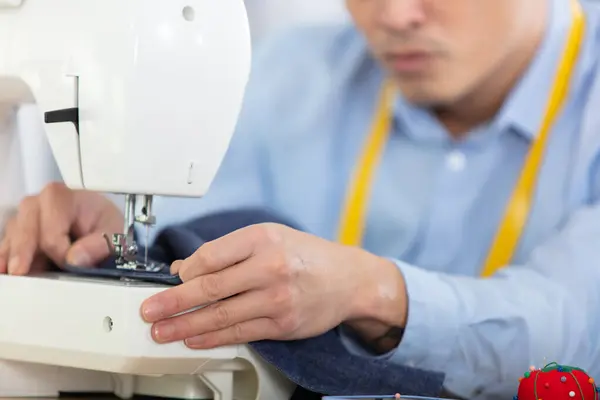 tailor man using sewing machine