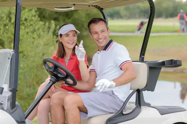 beautiful couple in a golf cart