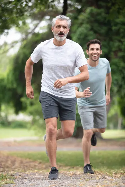 two men jogging in the park