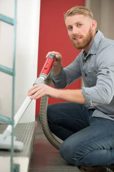 Young Man Vacuuming Tiled Staircase — Stock Photo, Image