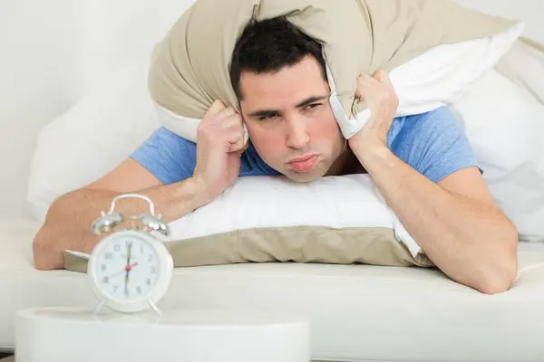 Grumpy Man Using Pillow Hide Alarm Clock Noise — Stock Photo, Image