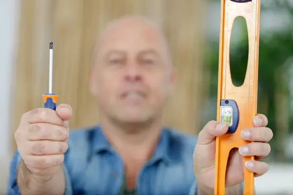 Positive Man Showing Tools — Stock Photo, Image