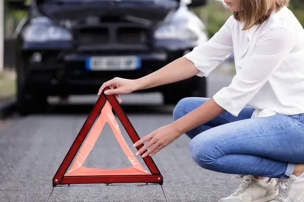 Young Woman Setting Safety Triangle — Stock Photo, Image