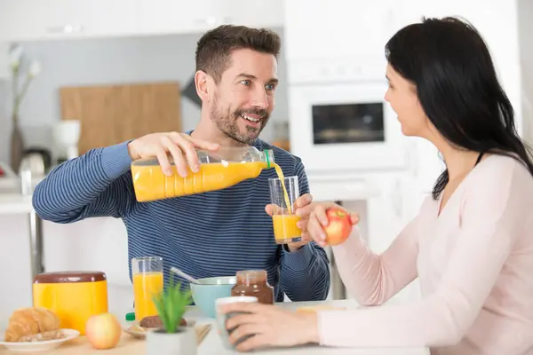 Handsome Positive Man Serving Orange Juice His Wife — Stock Photo, Image