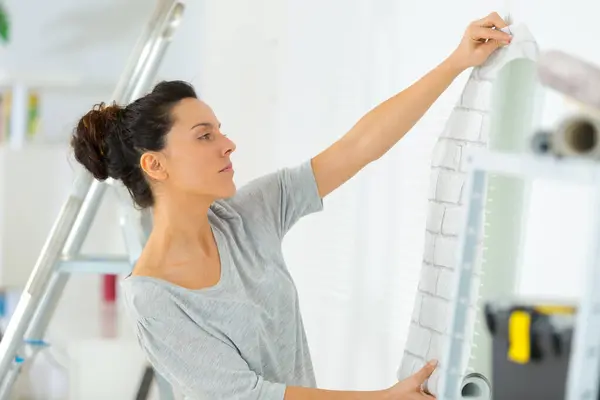 Portrait Woman Putting Wallpaper — Stock Photo, Image