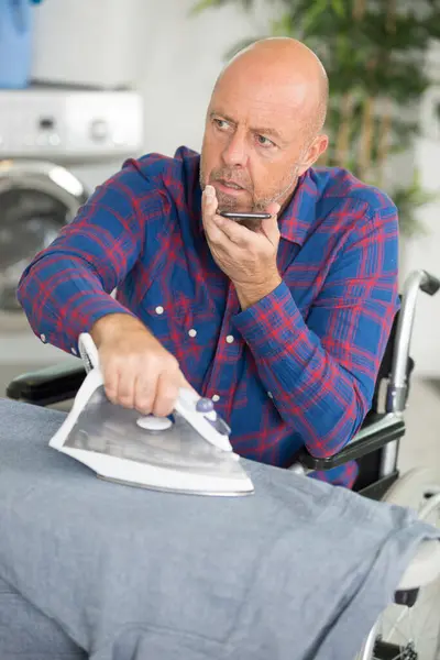 Disabled Man Phone While Ironing Clothing — Stock Photo, Image