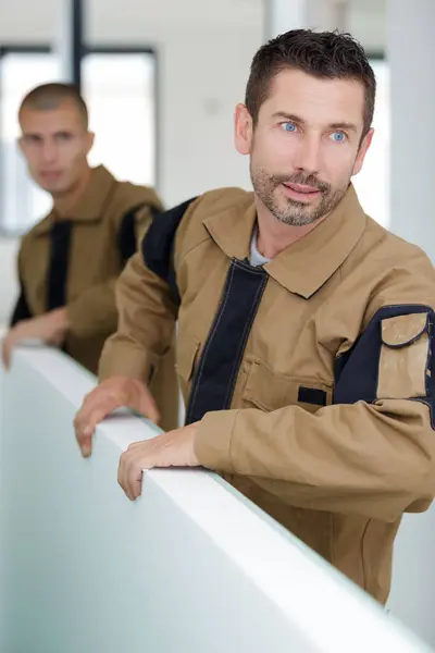 Builders Carrying Wooden Boards Indoors — Stock Photo, Image