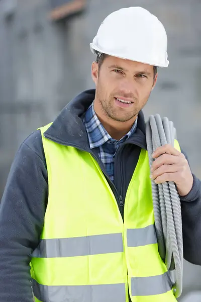 Handsome Tradesman Carrying Corrugated Tubing — Stock Photo, Image