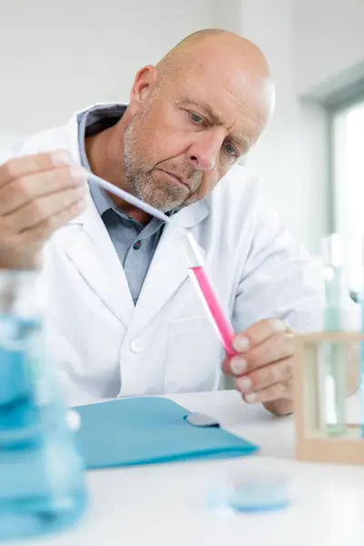 lab worker in uniform testing new substance