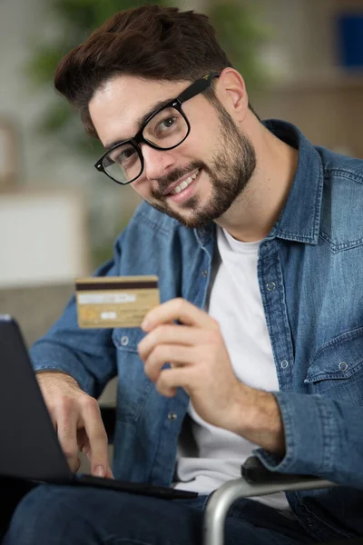 a happy young man buying online
