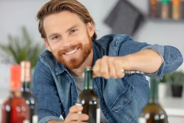 male open wine bottle with corkscrew