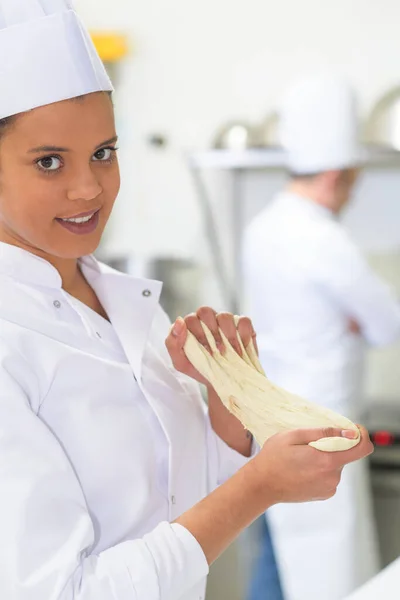 woman baker working on dough