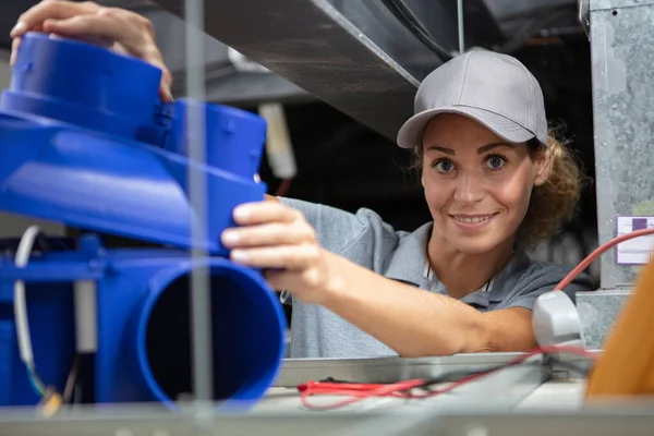 Young Female Worker Installing Plastic Ventilation Unit — Stock Photo, Image