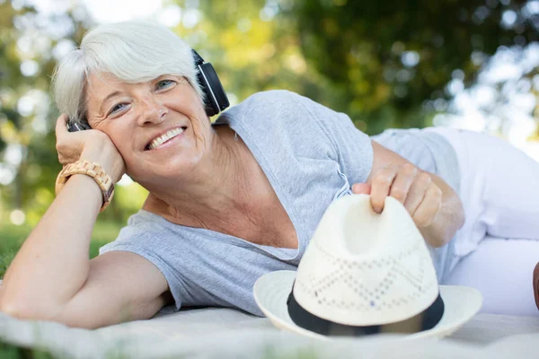 relaxed pensioner listening to music in nature