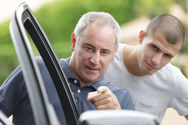Father Pointing Car Wingmirror Son Stood Him — Stock Photo, Image