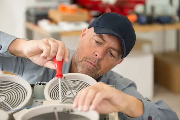 picture of man doing appliance repair