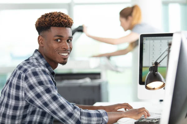 young man using a computer in an office