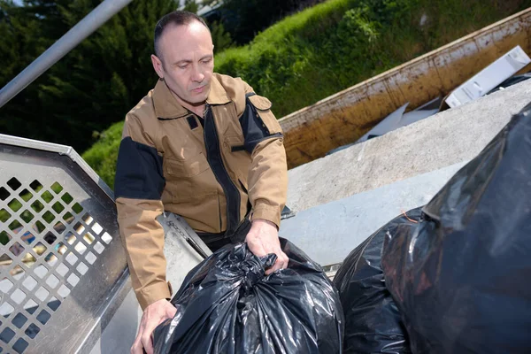 Worker Piling Black Garbage Bags — Stock Photo, Image