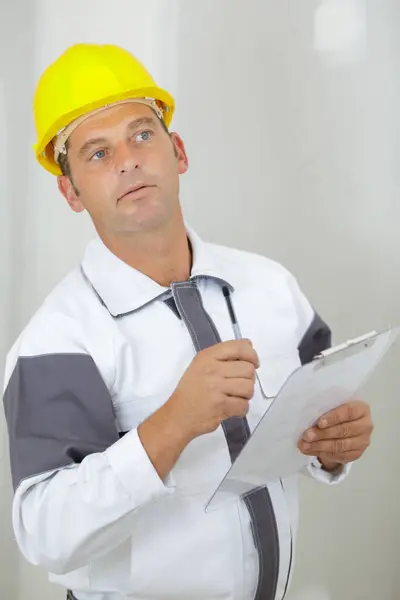 Male Builder Holding Clipboard Stock Image