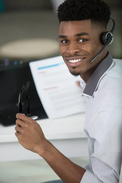 portrait of a young worker wearing telephone headset