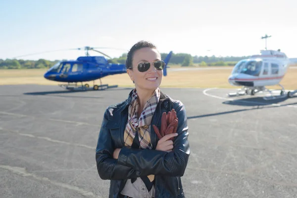 pretty pilot woman on helicopter background