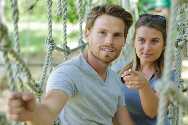 couple on a leisure time in a ropes course