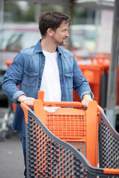 man in a shopping trolley