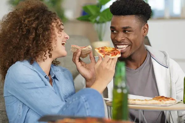 young couple with pizza at home