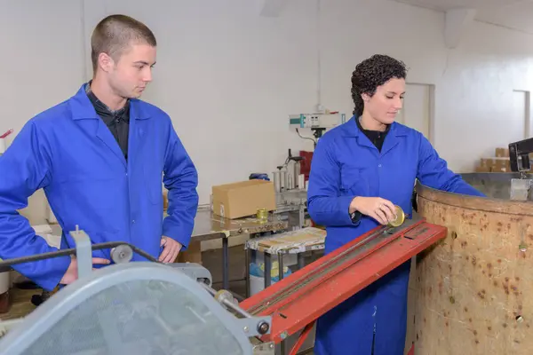 stock image young people working on a factory production line