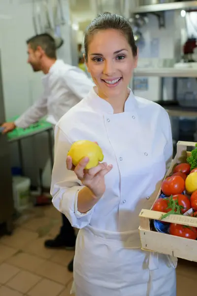 happy female chef with vegetables